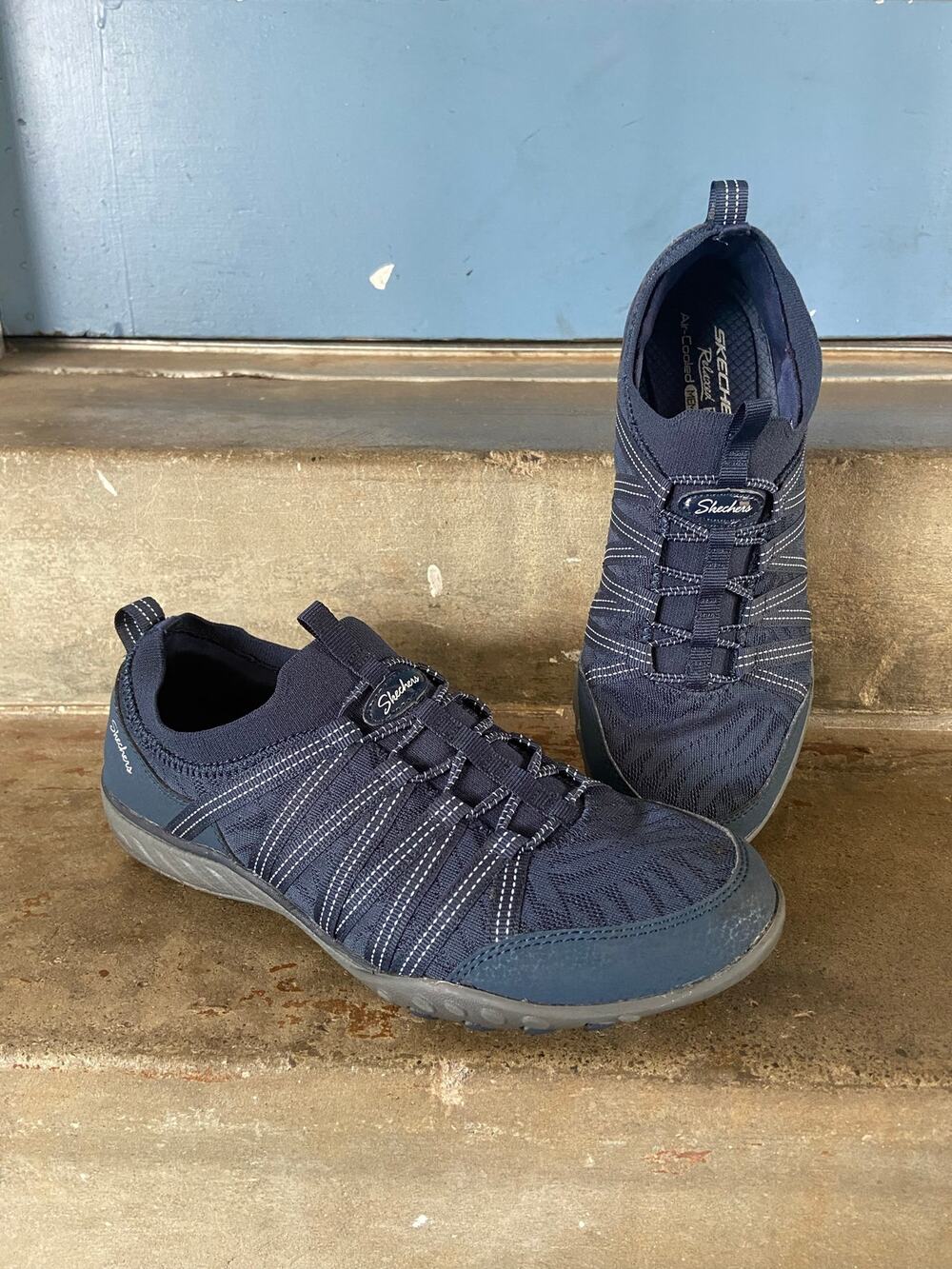 Skechers Breathe Easy navy blue slip on sneakers with bungee cord accent